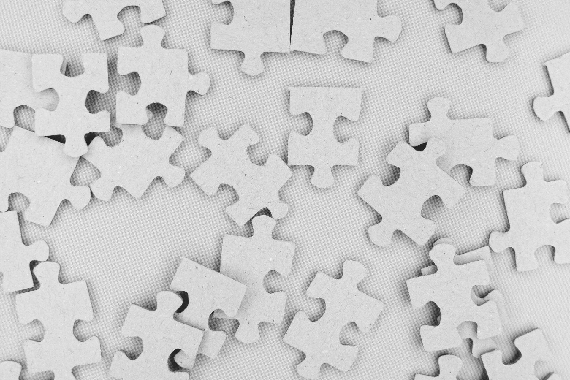 image of white puzzle pieces scattered on a table